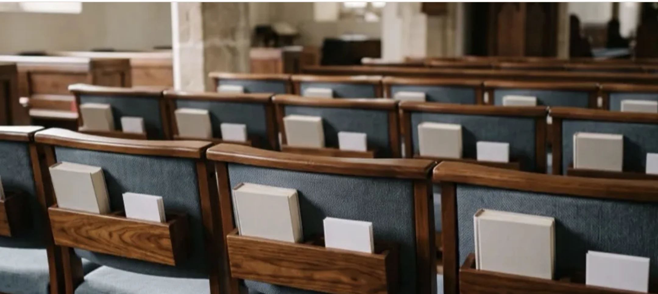 Wood-frame upholstered church chairs with rear book racks