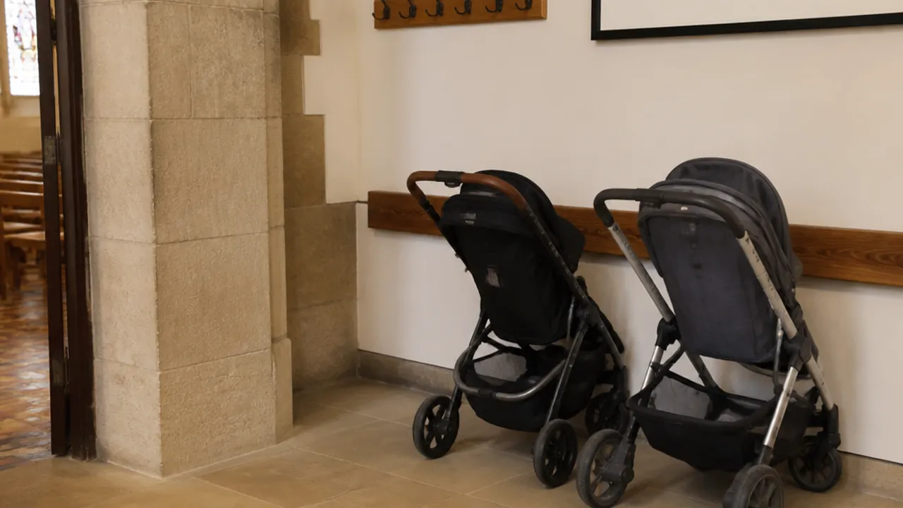 Stroller parking alcove just inside an entrance, with strollers parked along a low rail
